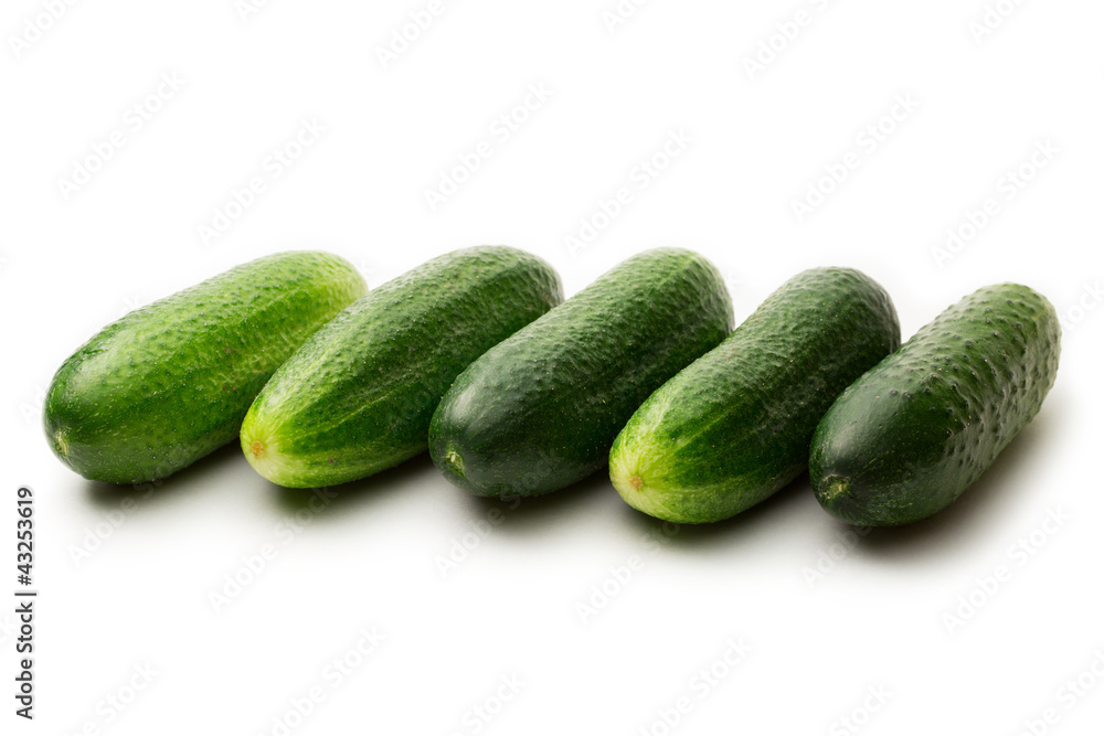 Fresh green cucumbers on white