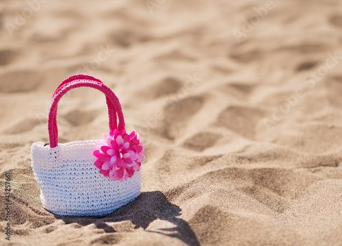 Closeup on child handbag on beach sand