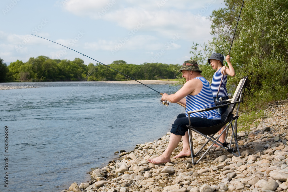 Grandfather and grandson fishing on weekend Grandfather and grandson fishing on weekend