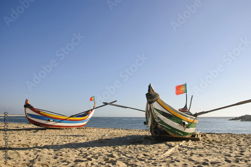 Typical portuguese fishing boat on the beach, Espinho, Portugal photo