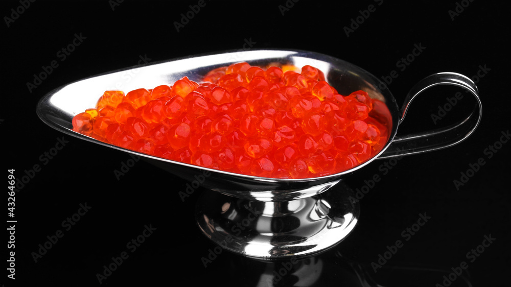 Red caviar in silver bowl isolated on black Red caviar in silver bowl isolated on black