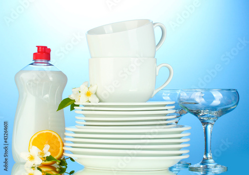 empty clean plates, glasses and cups with dishwashing liquid