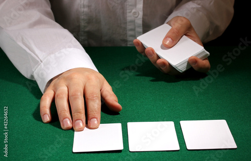 Cards in hands on green table photo