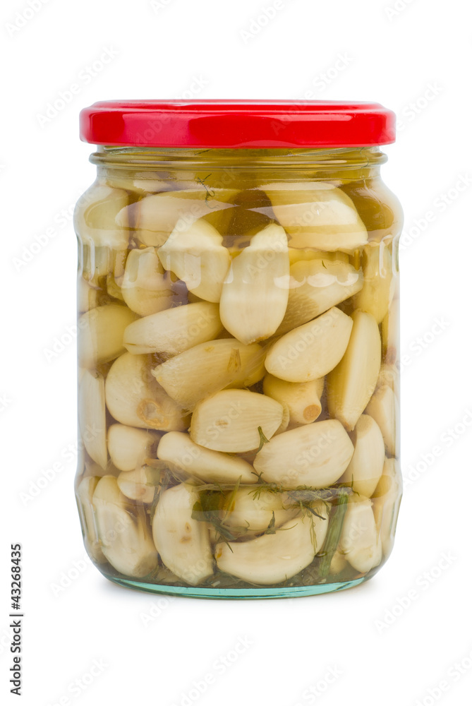 Glass jar with marinated garlic Glass jar with marinated garlic