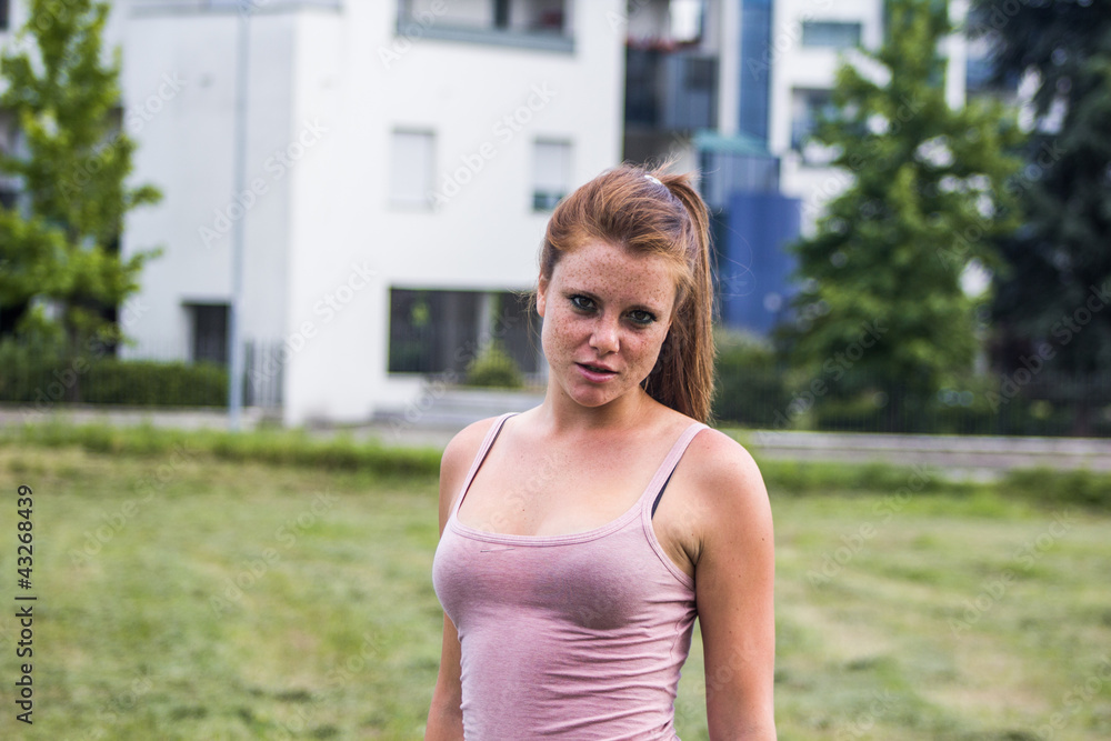 Sensual and tired girl keep fit in a urban landscape