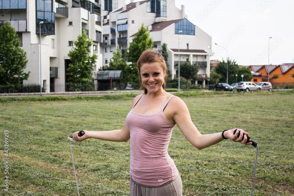 Sensual and happy girl keep fit in a urban landscape