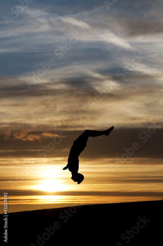 silhouette of gymnast in sunset