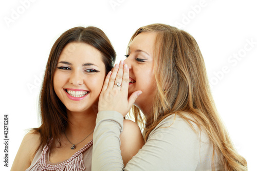 Two happy girls friends wispering photo
