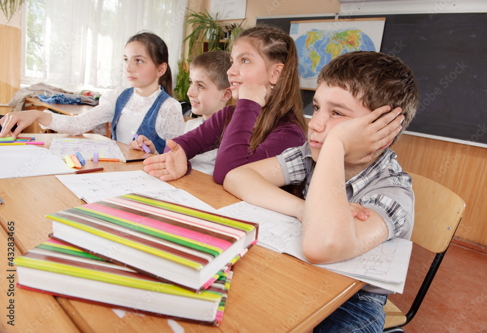 Schoolchildren at classroom during a lesson Schoolchildren at classroom during a lesson