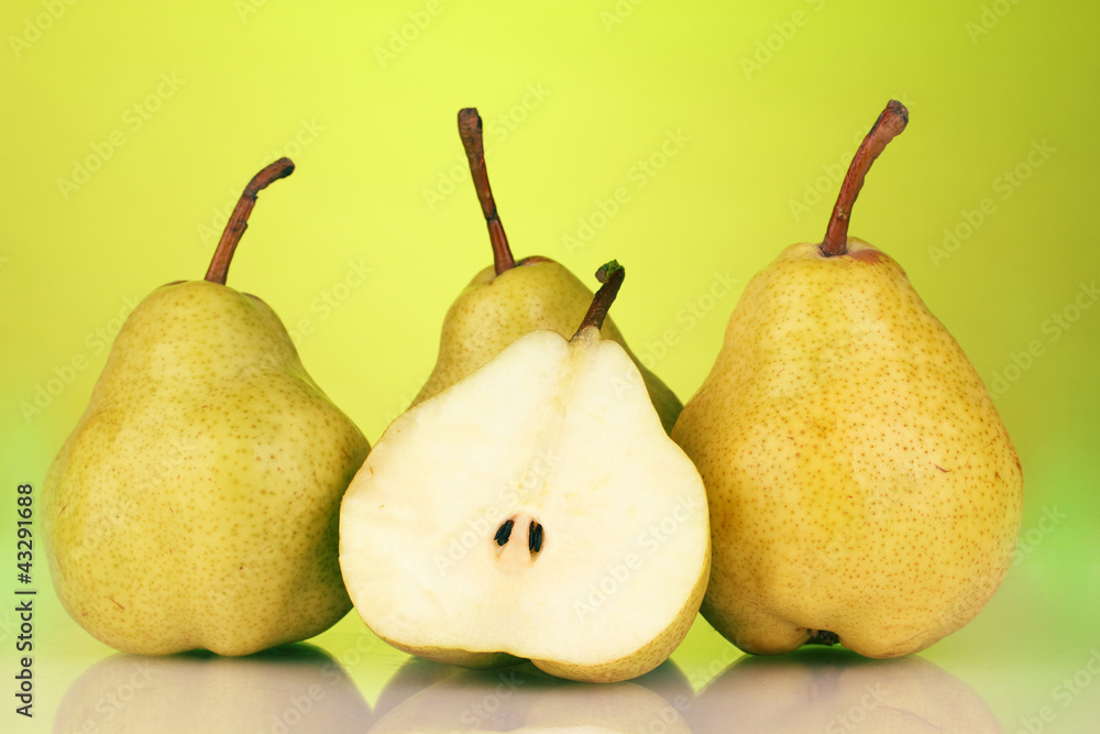 Ripe pears on bright green background Ripe pears on bright green background