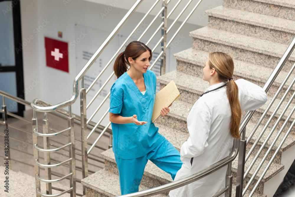 Nusre and doctor talking in a stairwell Nusre and doctor talking in a stairwell