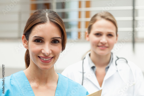 Smiling nurse and doctor standing