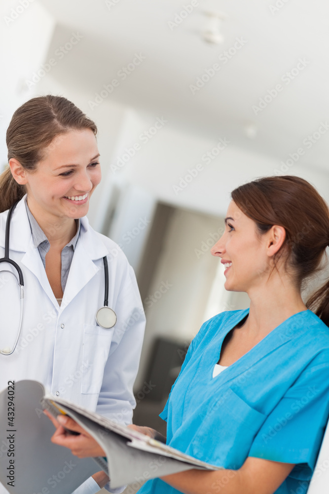 Doctor and nurse smiling while looking at each other Doctor and nurse smiling while looking at each other