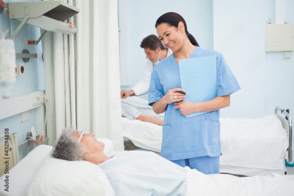 Nurse smiling to a patient Nurse smiling to a patient