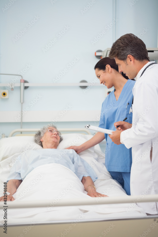 Doctor and nurse talking with a patient Doctor and nurse talking with a patient