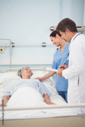 Doctor and nurse speaking to a patient