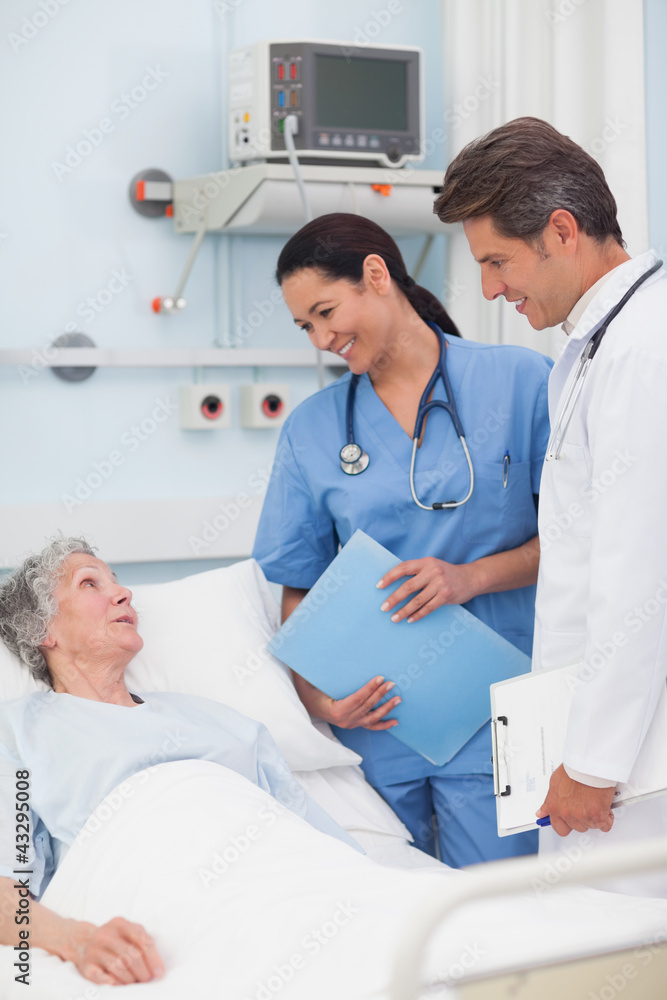 Elderly patient talking to a doctor and a nurse Elderly patient talking to a doctor and a nurse