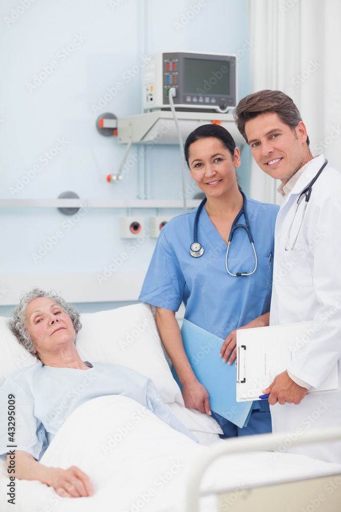 Fototapeta premium Patient with her doctor and nurse looking at camera