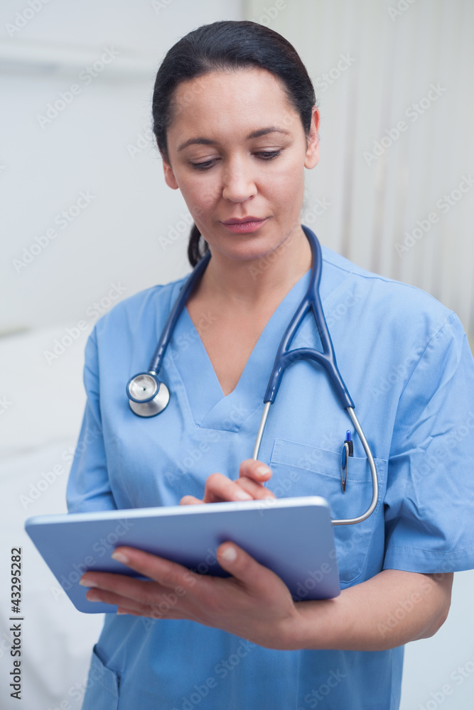 Nurse touching a tablet computer Nurse touching a tablet computer