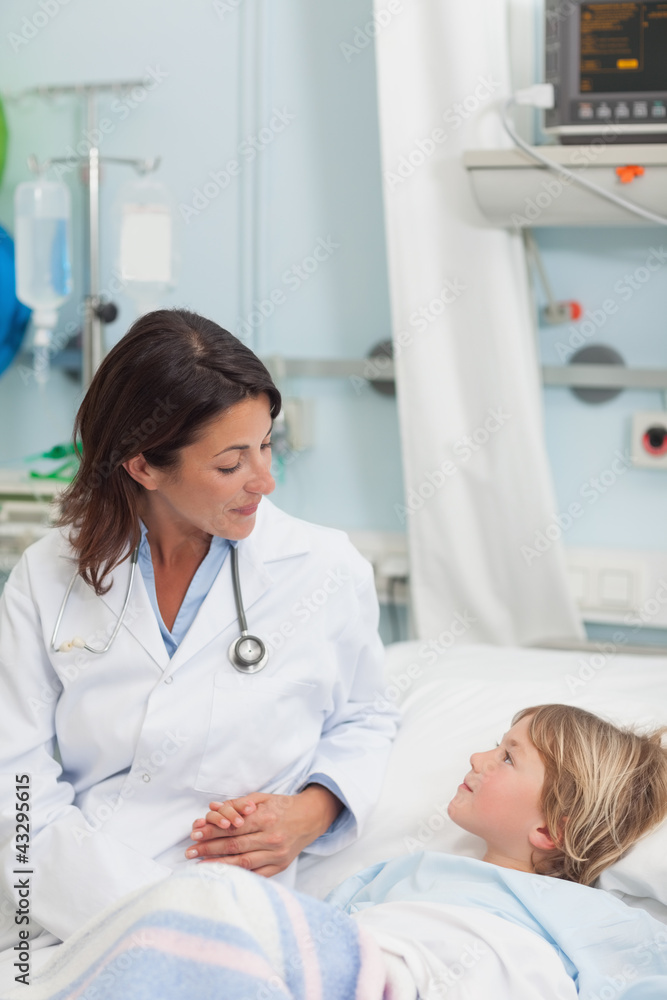 Fototapeta premium Doctor holding the hand of a child