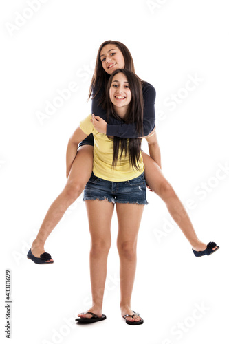 Sisters riding piggyback