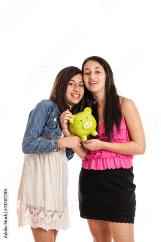 Teen girls with piggy bank photo