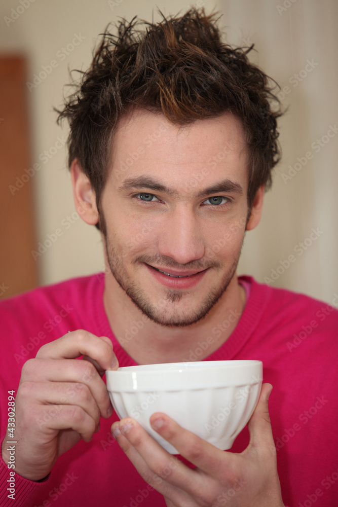 young man drinking his morning coffee young man drinking his morning coffee