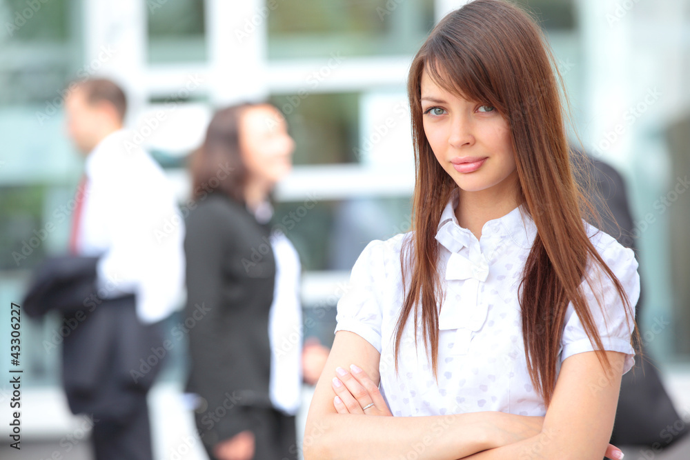 Face of beautiful woman on the background of business people Face of beautiful woman on the background of business people
