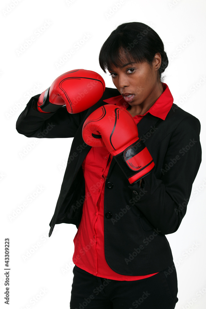 Businesswoman wearing boxing gloves Businesswoman wearing boxing gloves