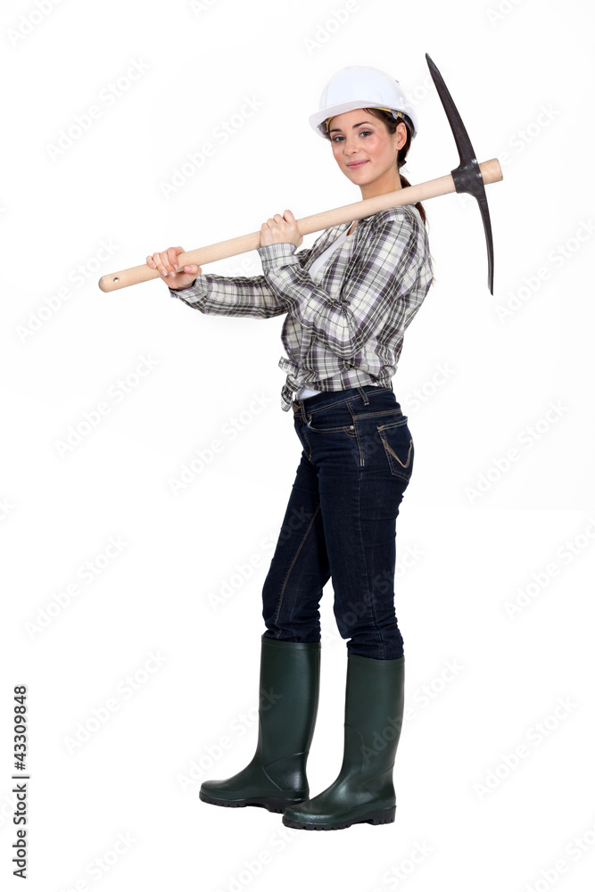 beautiful craftswoman holding a pick on her shoulder