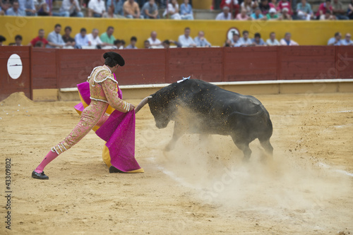 Torero toreando en una corrida típica española. photo
