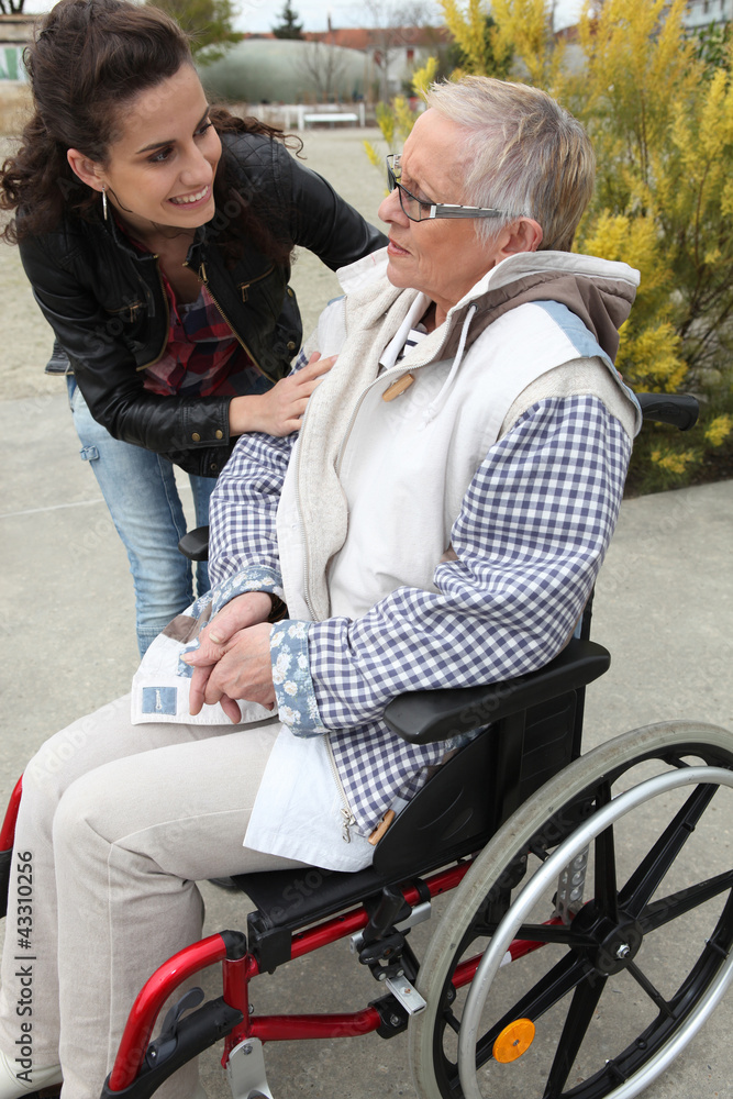 Young woman comforting her grandmother