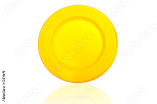 reflection of yellow plastic dish on white background