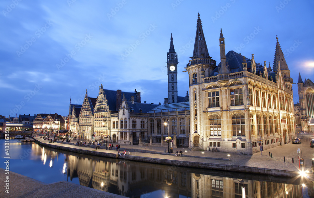 Gent - West facade of Post palace with the canal in evening