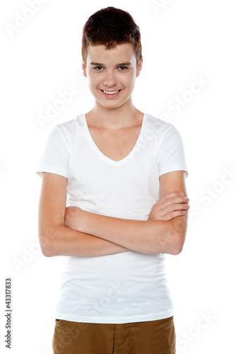 Smiling boy posing with crossed arms photo