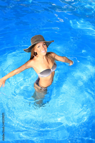 Young woman enjoying a swimming pool