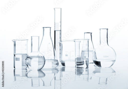 Set of classic laboratory flasks with a clear liquid, isolated