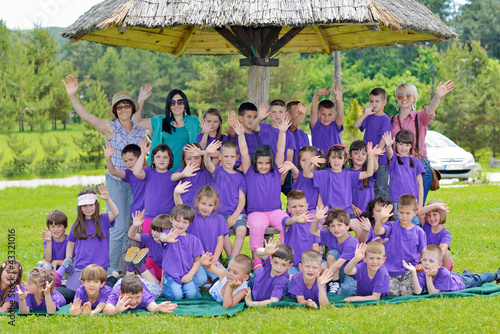 happy kids group with teacher in nature