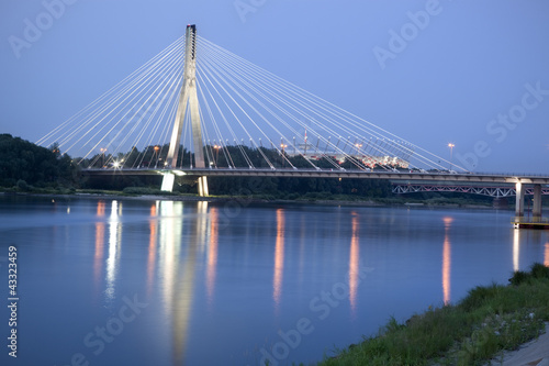 Modern bridge over Vistula River at night. Warsaw, Poland