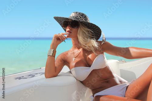 Sexy woman with hat on a luxury yach photo