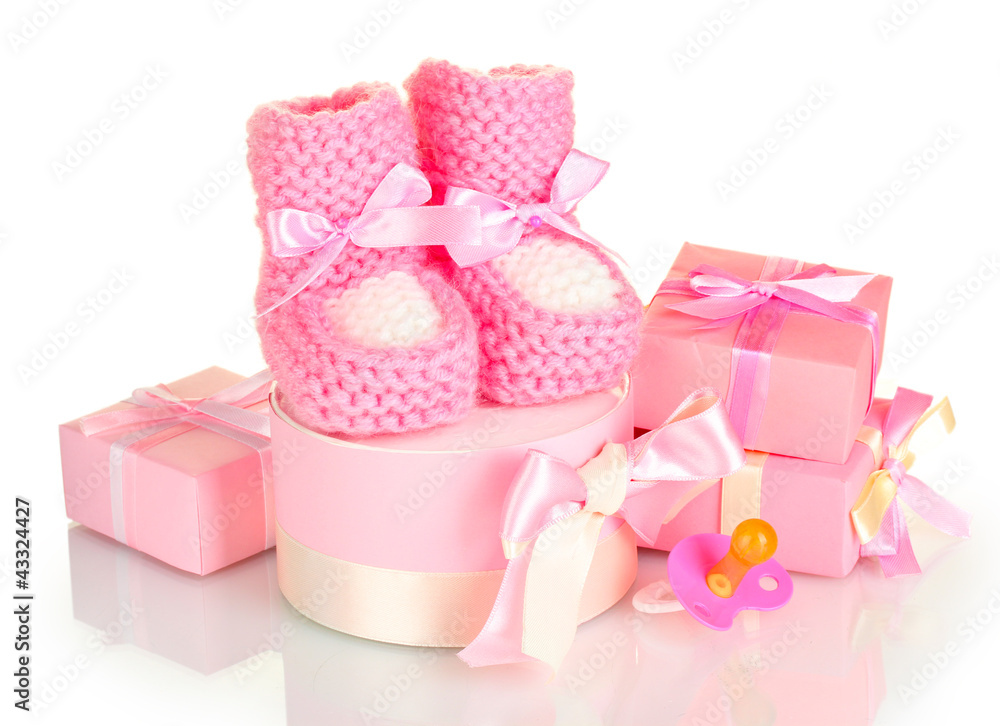 pink baby boots, pacifier and gifts isolated on white pink baby boots, pacifier and gifts isolated on white