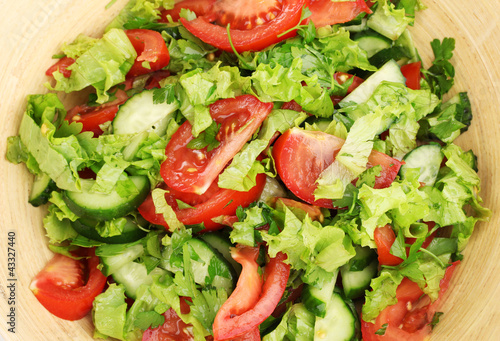 Fresh salad with tomatoes and cucumbers close-up