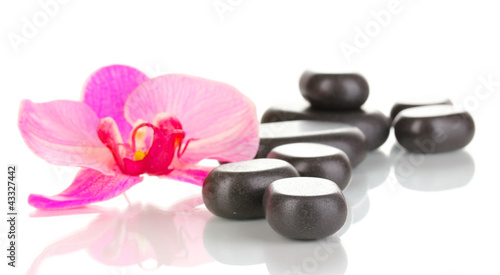 Spa stones with orchid flower isolated on white