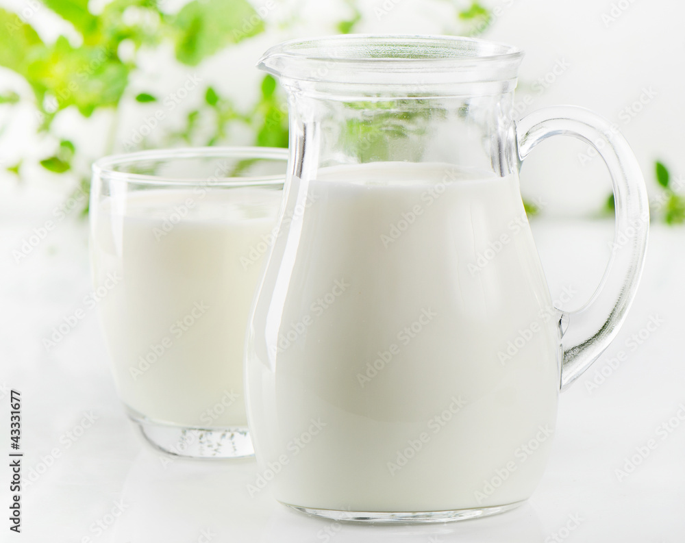 Glass jug and glass with milk