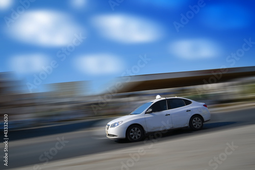 White car speeding with motion blur with blue sky © ayedmoeed