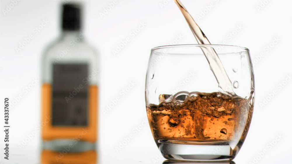 Bourbon in super slow motion filling a glass Bourbon in super slow motion filling a glass