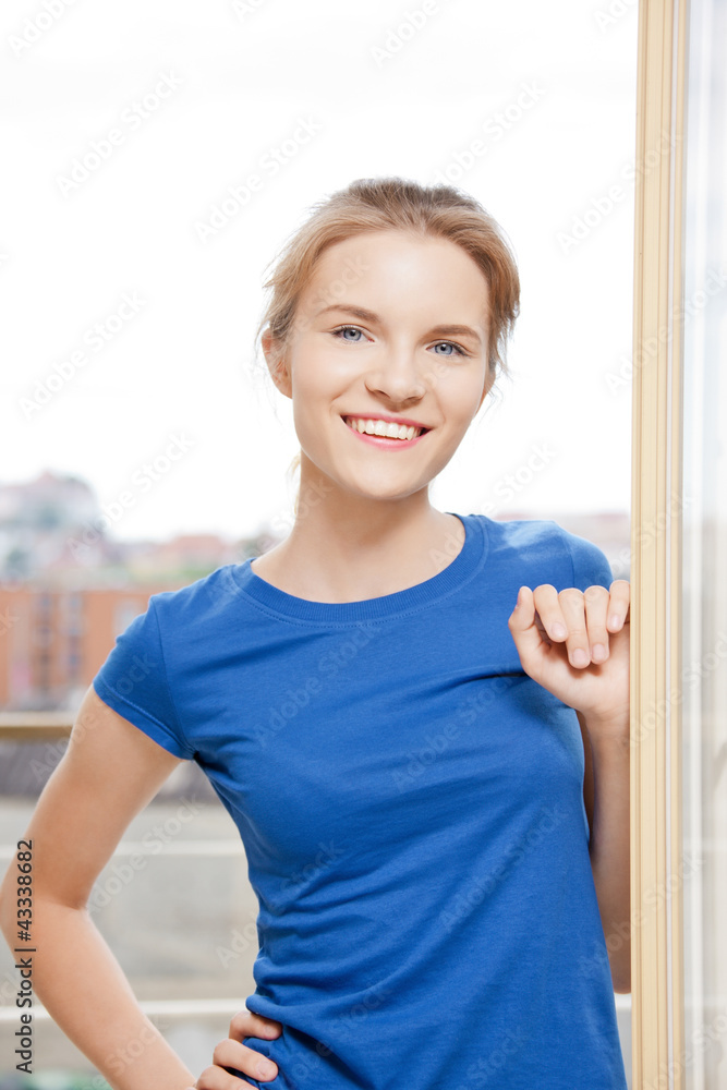 happy teenage girl at the window