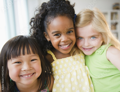 Smiling girls hugging each other