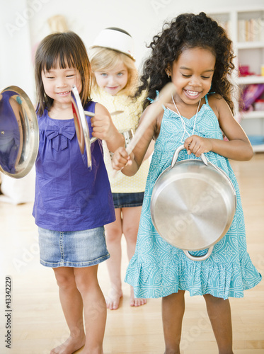 Girls making music with pots and pans