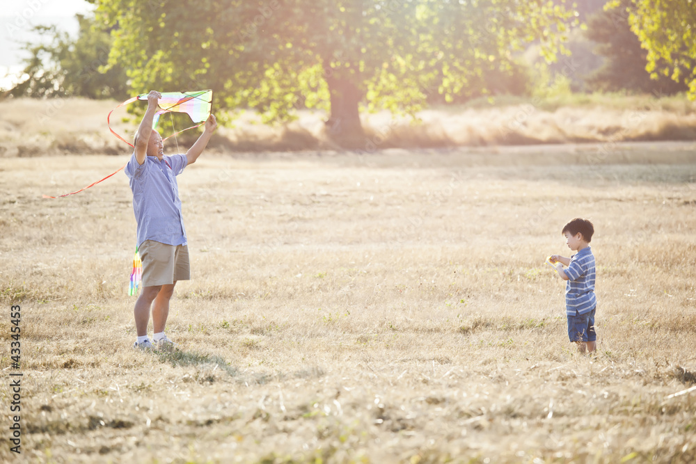 Chinese grandfather and grandson flying kite Chinese grandfather and grandson flying kite